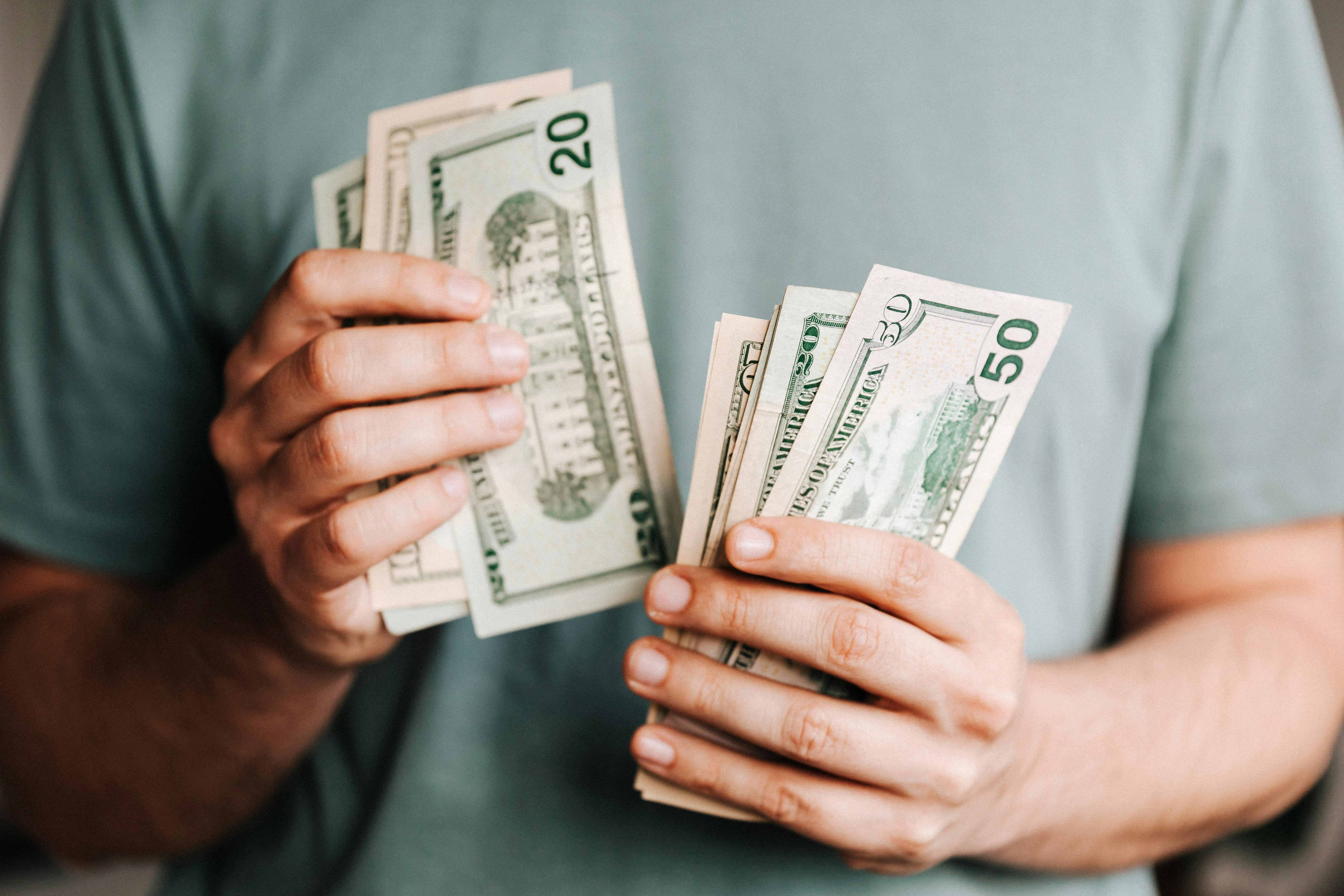 someone counting cash from one hand to the other